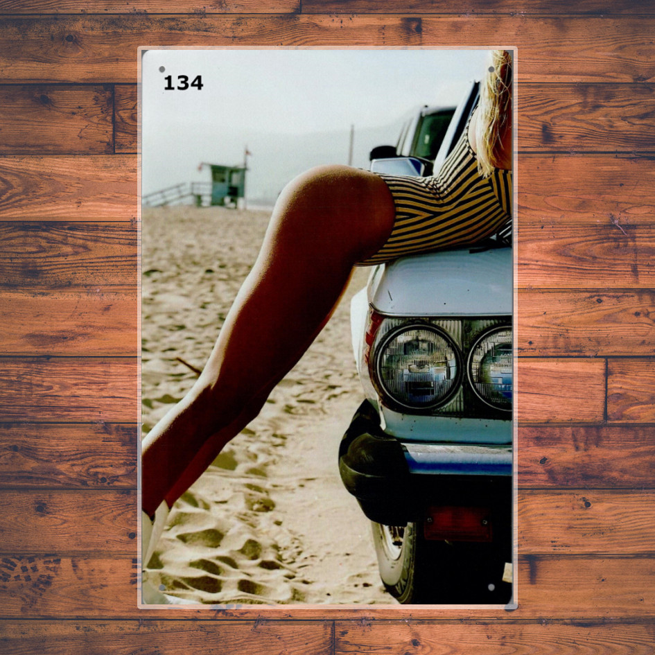 134 - Lady in bikini on a car at the beach